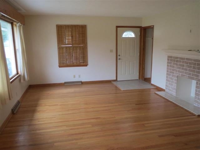 6103 Park Ridge Road Loves Park, IL 61111 - Photo 16 of 22 an empty room with wooden floor and windows