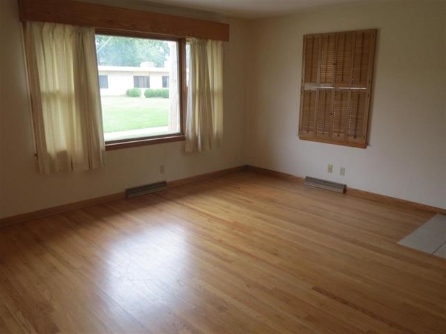 6103 Park Ridge Road Loves Park, IL 61111 - Photo 20 of 22 an empty room with wooden floor and windows