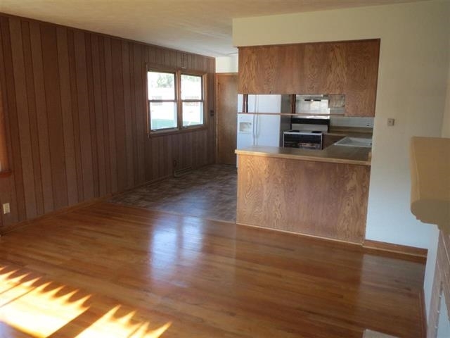 6103 Park Ridge Road Loves Park, IL 61111 - Photo 8 of 22 a kitchen with wooden floors and wooden cabinets