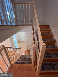 a view of staircase with white walls and a window