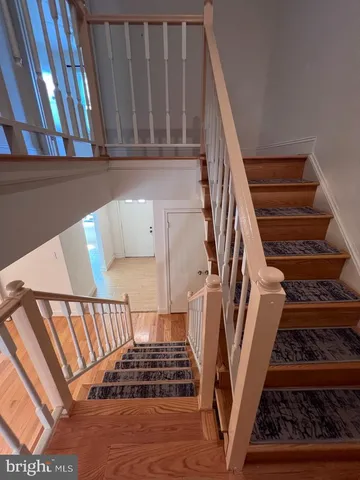 a view of staircase with white walls and a window