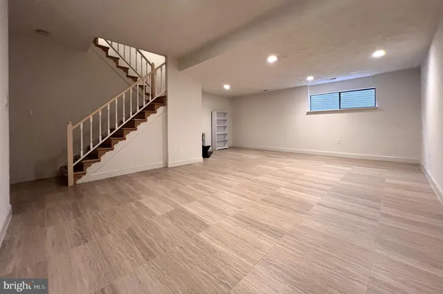 a view of a room with wooden floor and stairs