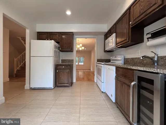a kitchen with a refrigerator sink and microwave