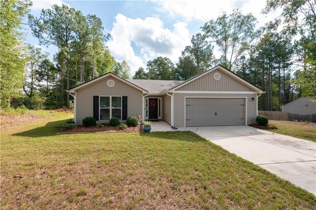 615 Shoal Creek Road Colbert, GA 30628 - Photo 1 of 1 a front view of a house with yard and garage