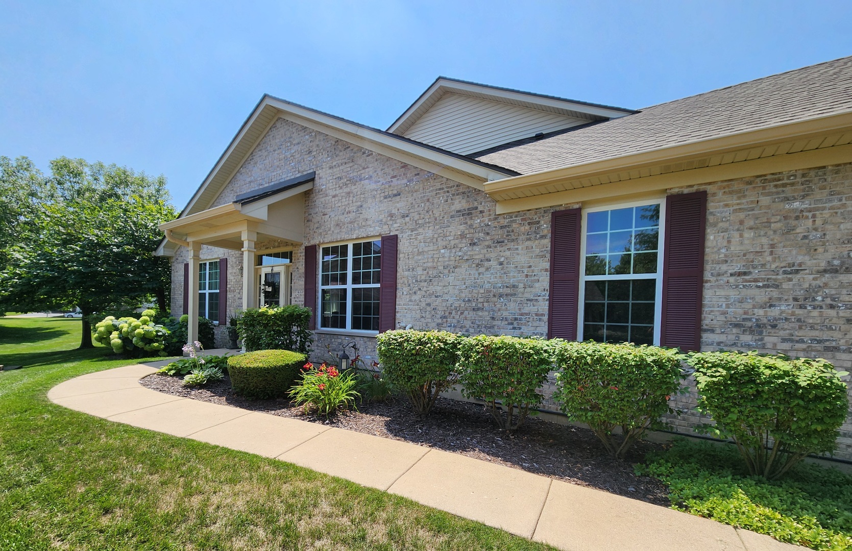 982 Oak Ridge Boulevard Elgin, IL 60120 - Photo 2 of 27 a view of a house with brick walls plants and large tree