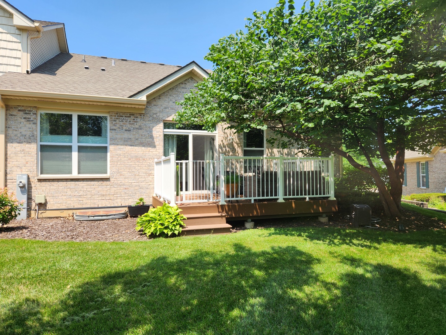 982 Oak Ridge Boulevard Elgin, IL 60120 - Photo 24 of 27 a view of a house with a backyard and a garden