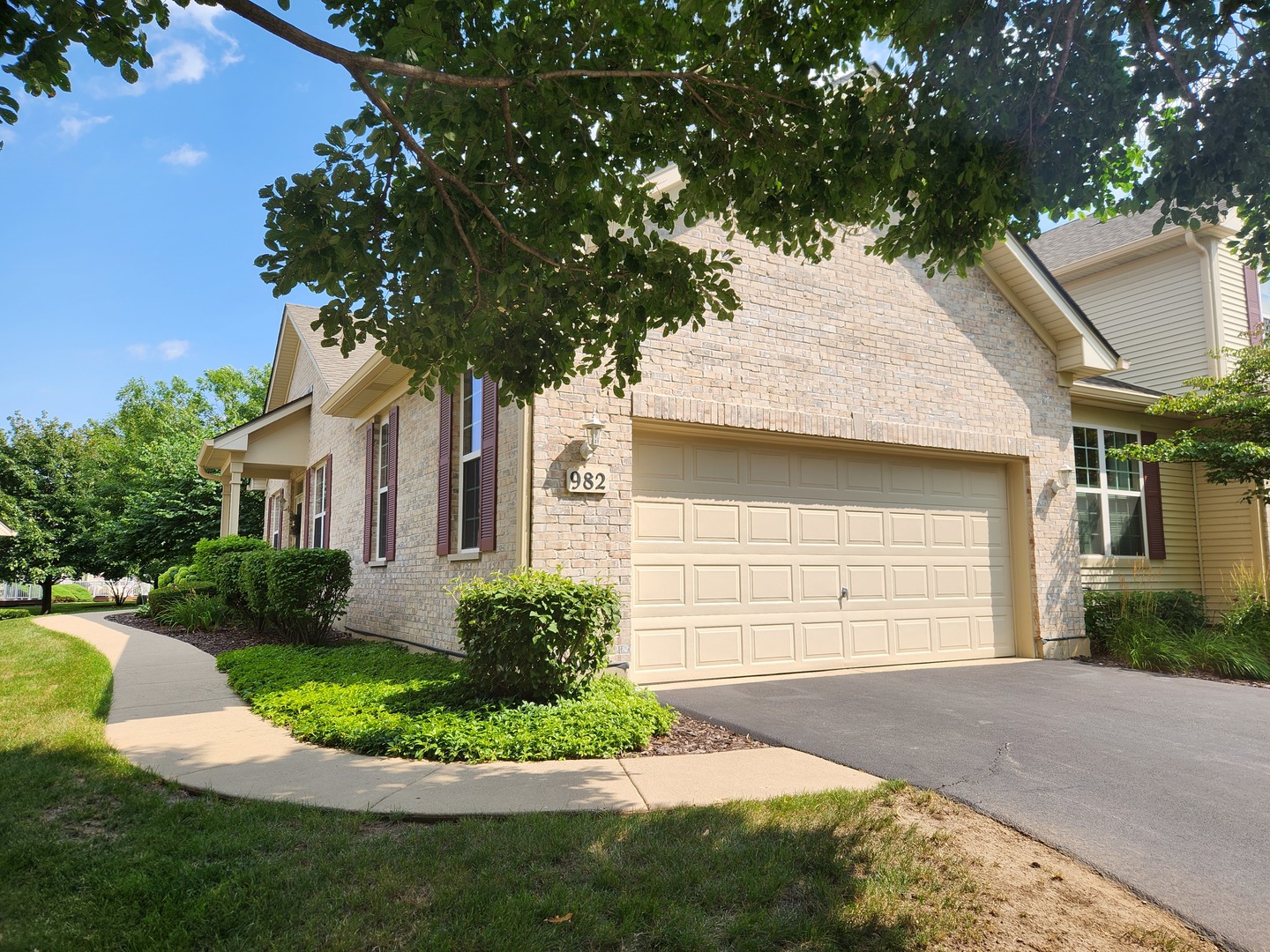982 Oak Ridge Boulevard Elgin, IL 60120 - Photo 3 of 27 a front view of a house with a yard and garage