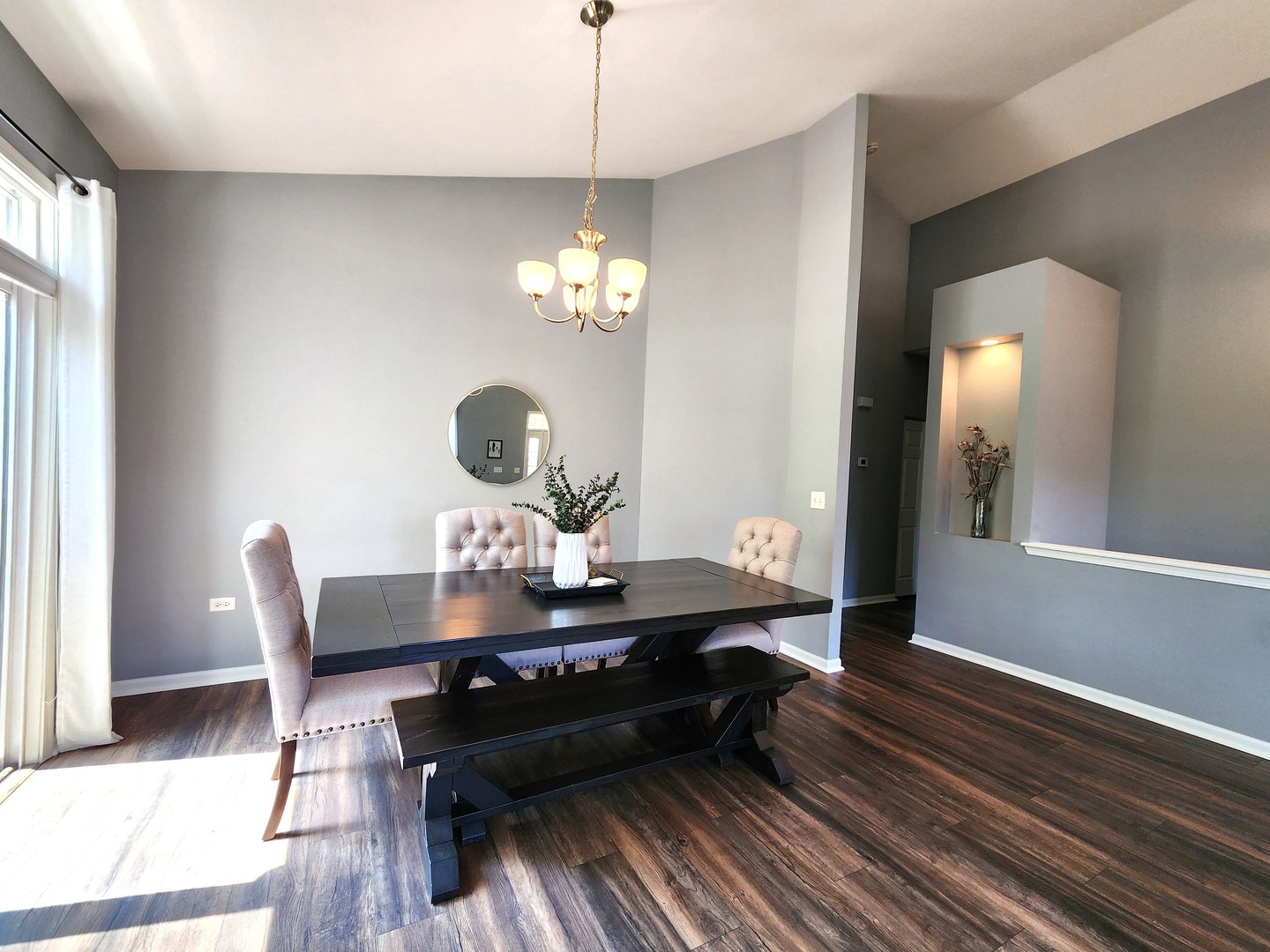 982 Oak Ridge Boulevard Elgin, IL 60120 - Photo 8 of 27 a dining room with wooden floor a chandelier a glass table and chairs
