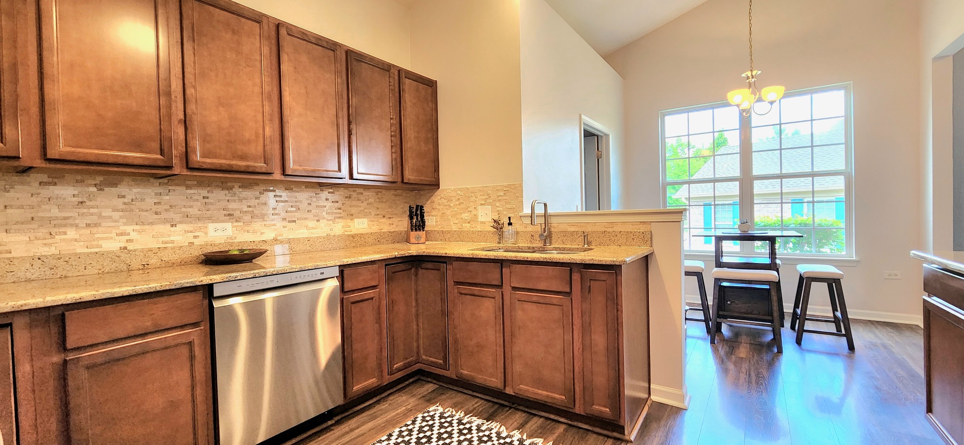 982 Oak Ridge Boulevard Elgin, IL 60120 - Photo 9 of 27 a kitchen with stainless steel appliances granite countertop wooden cabinets a sink a stove a dining table and chairs