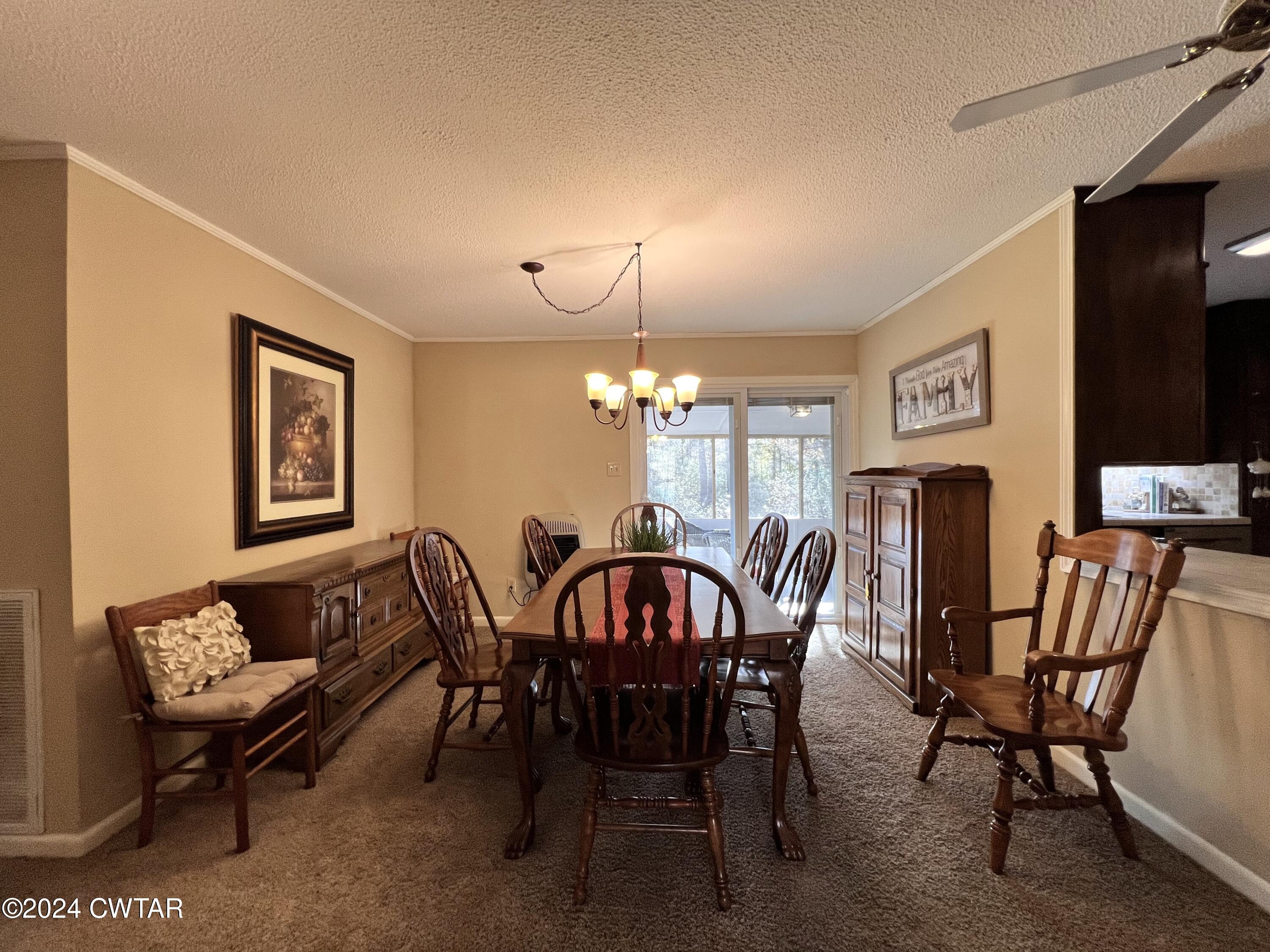 2390 Harts Bridge Road Jackson, TN 38301 - Photo 7 of 36 a view of a dining room with furniture and chandelier