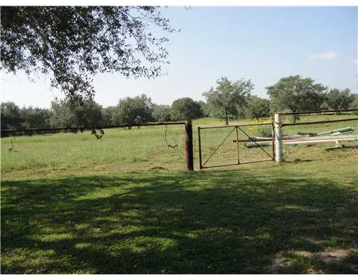 a view of outdoor space with green field and trees