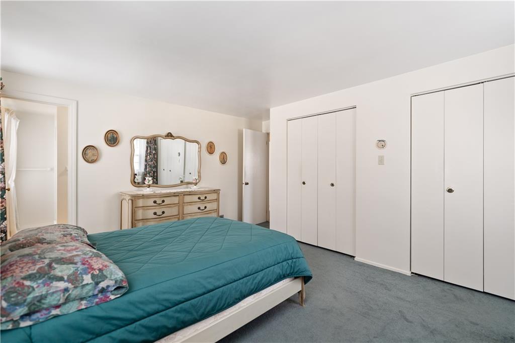 43 Jaycee Drive Pittsburgh, PA 15243 - Photo 19 of 38 a bedroom with a large bed and a chandelier