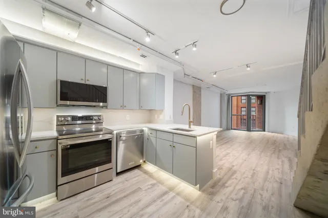 a kitchen with stainless steel appliances granite countertop a stove and a refrigerator