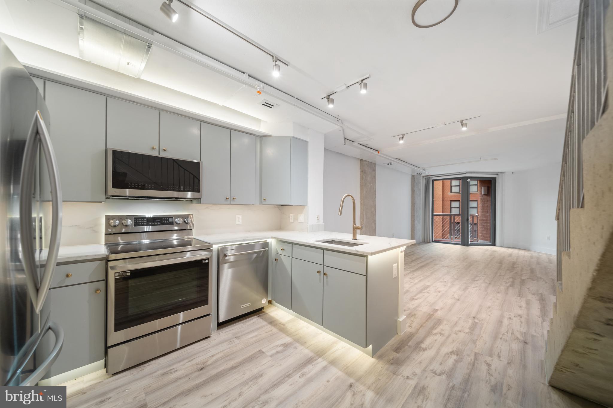 a kitchen with stainless steel appliances granite countertop a stove and a refrigerator