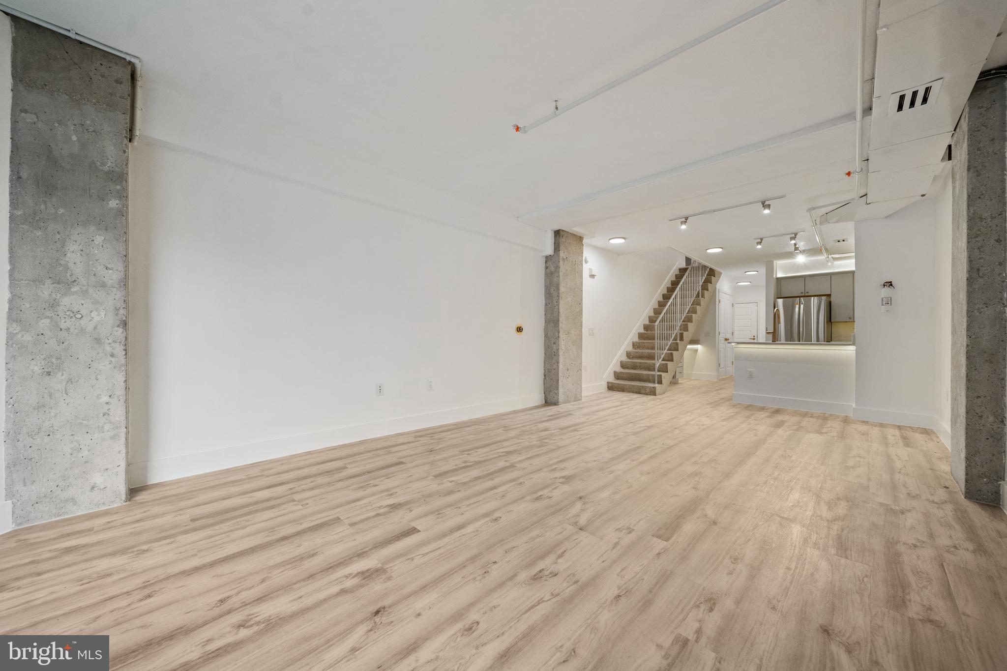 616 E Street Northwest, Unit 856 Washington, DC 20004 - Photo 11 of 84 a view of a hallway with wooden floor and a fireplace