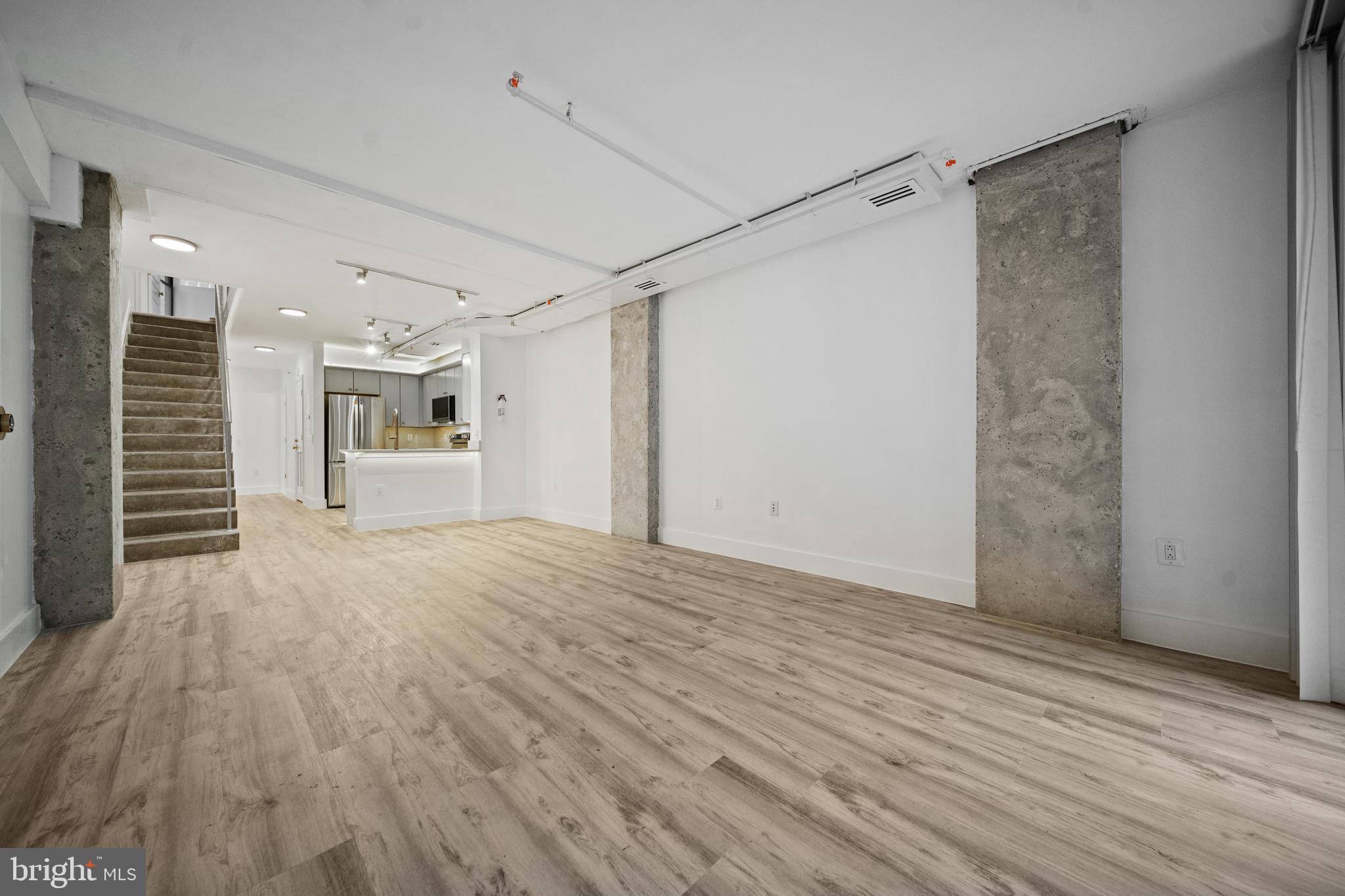 616 E Street Northwest, Unit 856 Washington, DC 20004 - Photo 12 of 84 a view of a room with wooden floor and a ceiling fan