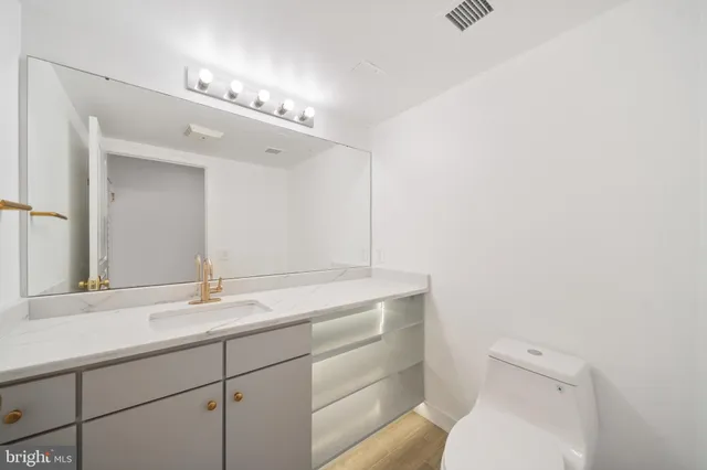 a view of an empty room and wooden floor