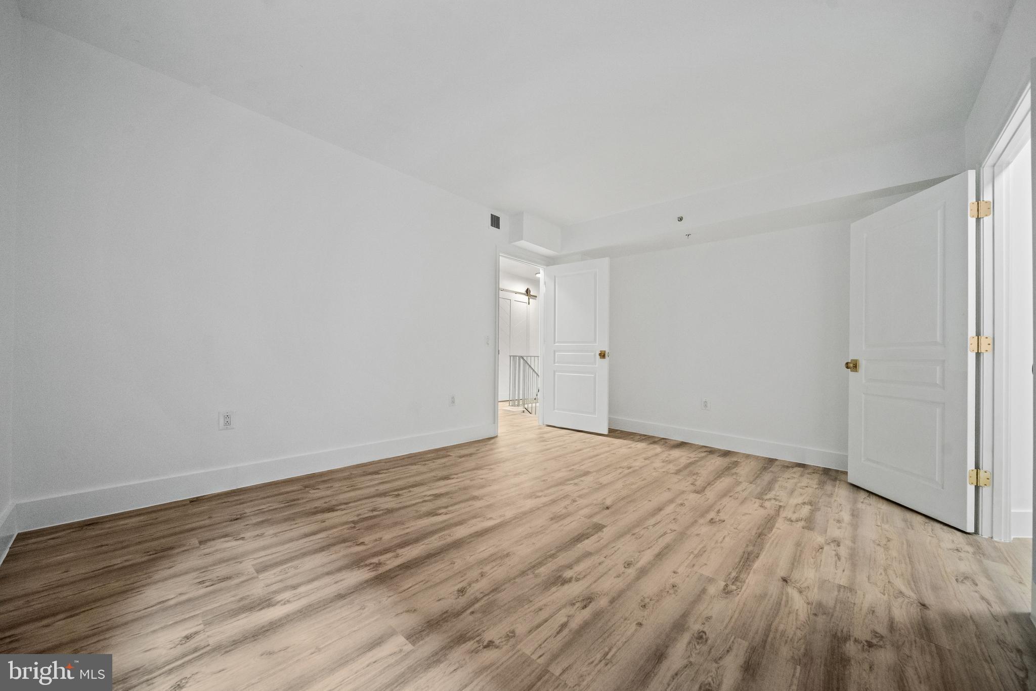 616 E Street Northwest, Unit 856 Washington, DC 20004 - Photo 19 of 84 a view of an empty room and wooden floor