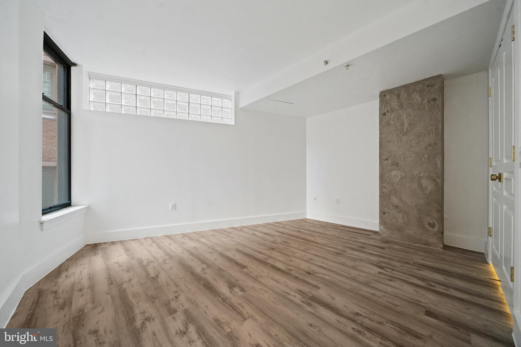 616 E Street Northwest, Unit 856 Washington, DC 20004 - Photo 20 of 84 a view of an empty room with wooden floor and a window