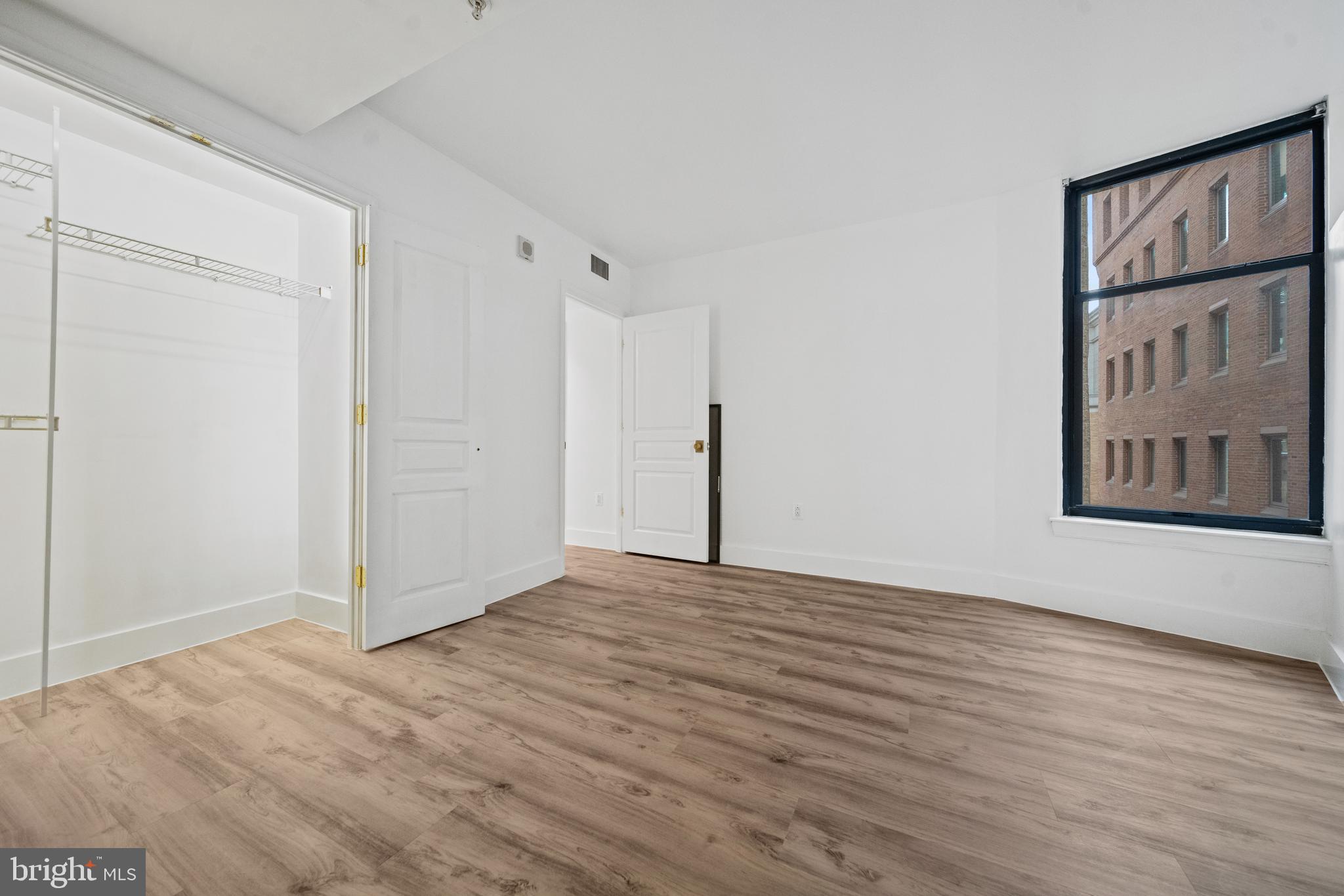 616 E Street Northwest, Unit 856 Washington, DC 20004 - Photo 21 of 84 a view of an empty room with wooden floor