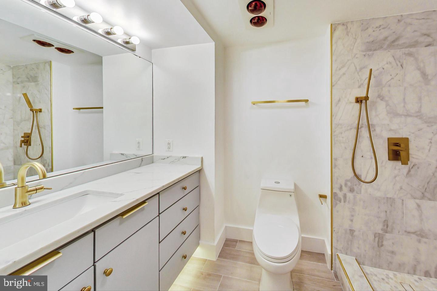 616 E Street Northwest, Unit 856 Washington, DC 20004 - Photo 24 of 84 a bathroom with a granite countertop sink a toilet and a shower