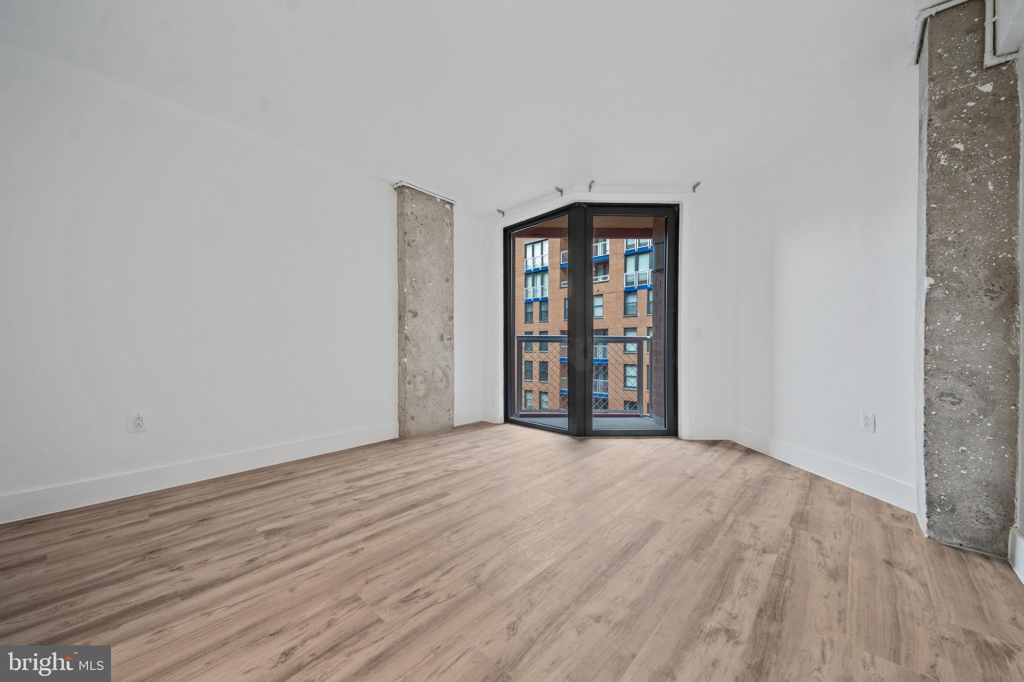 616 E Street Northwest, Unit 856 Washington, DC 20004 - Photo 26 of 84 wooden floor and window in an empty room
