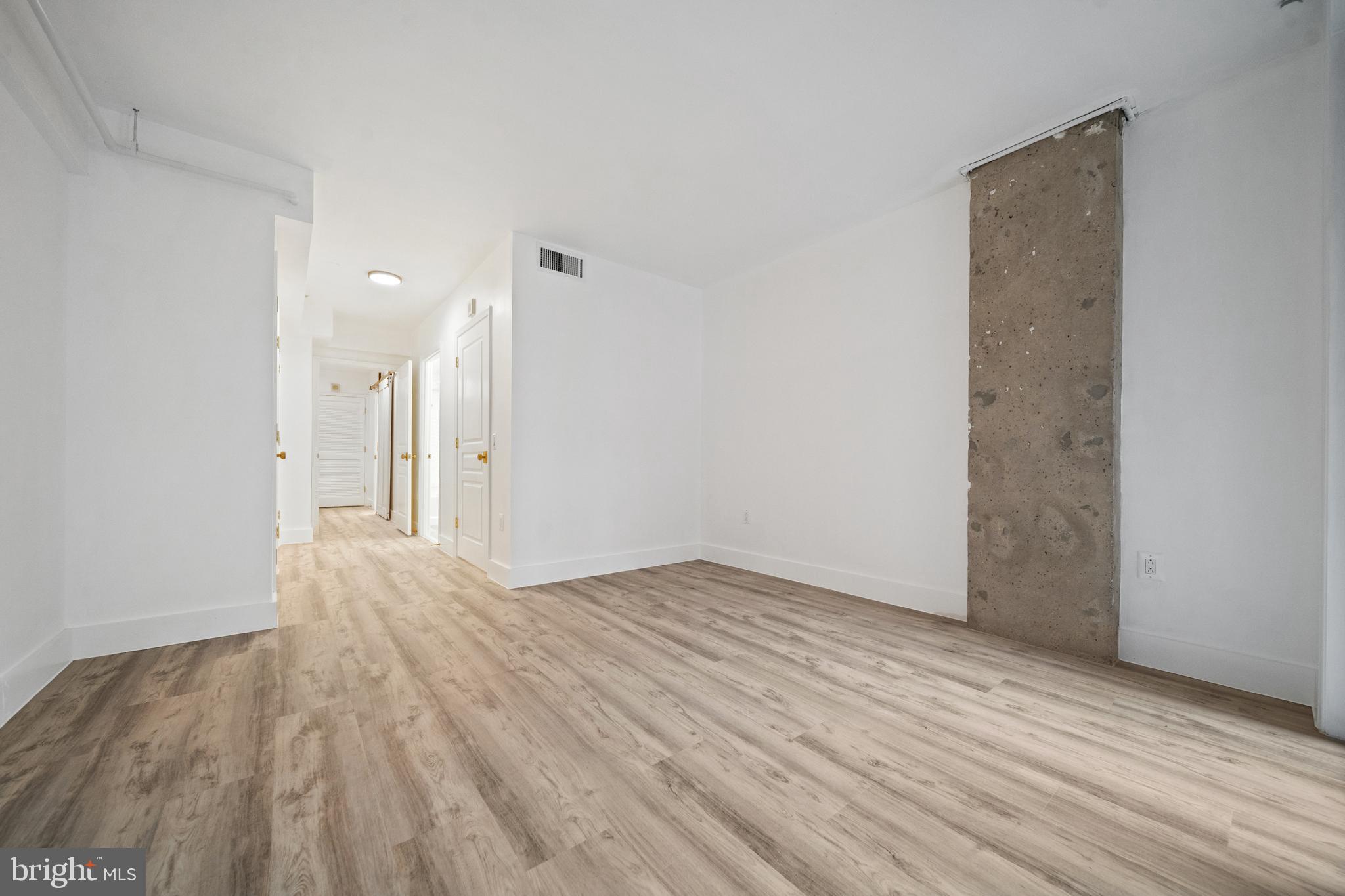 616 E Street Northwest, Unit 856 Washington, DC 20004 - Photo 28 of 84 a view of an empty room with wooden floor