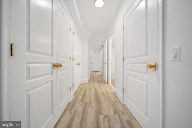 a bathroom with a granite countertop sink a toilet and a mirror