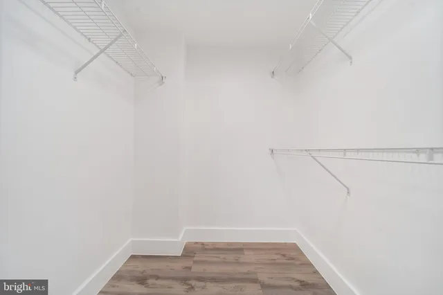 a living room with furniture a fireplace and a floor to ceiling window