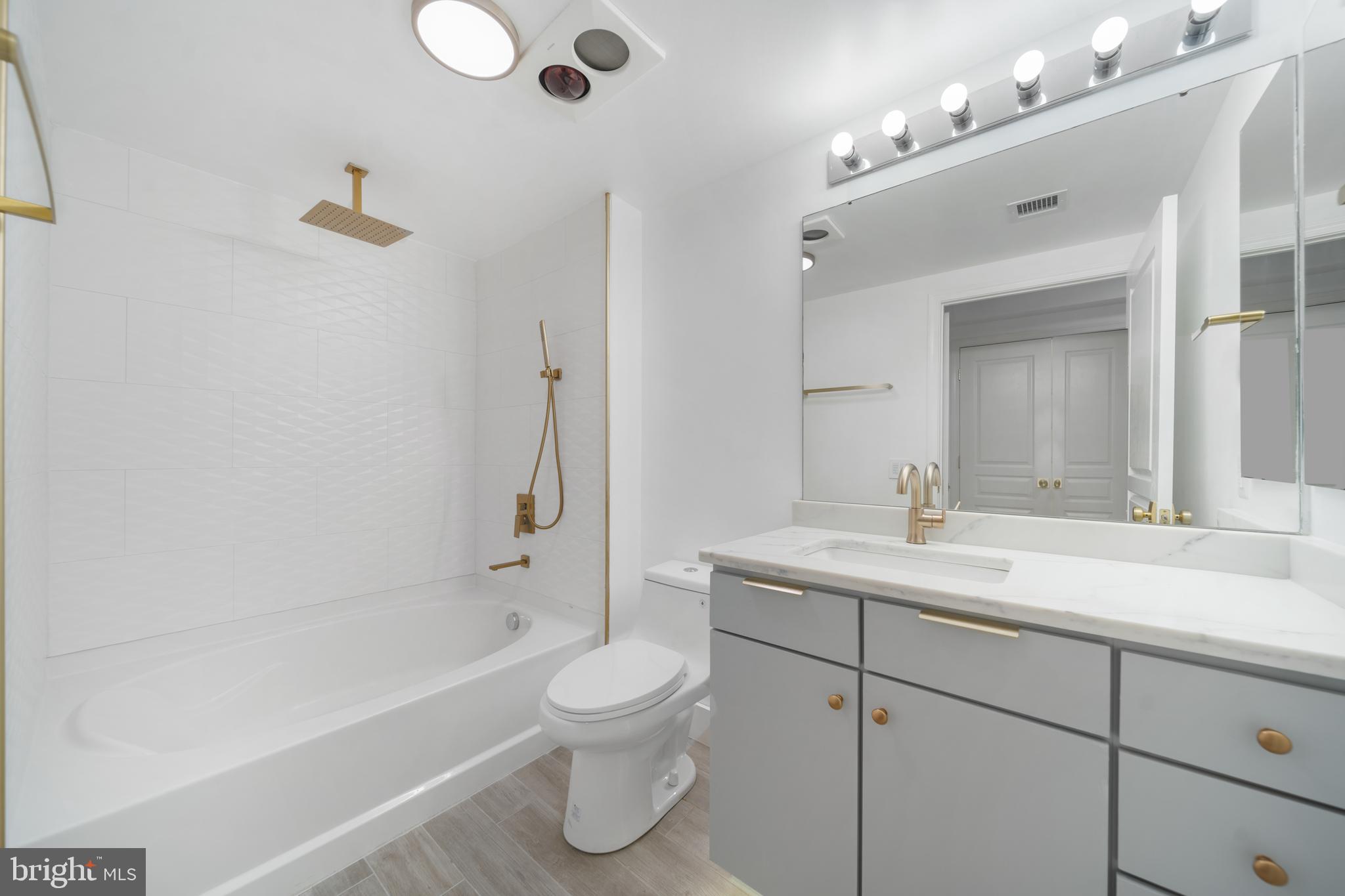616 E Street Northwest, Unit 856 Washington, DC 20004 - Photo 33 of 84 a bathroom with a sink a toilet and shower