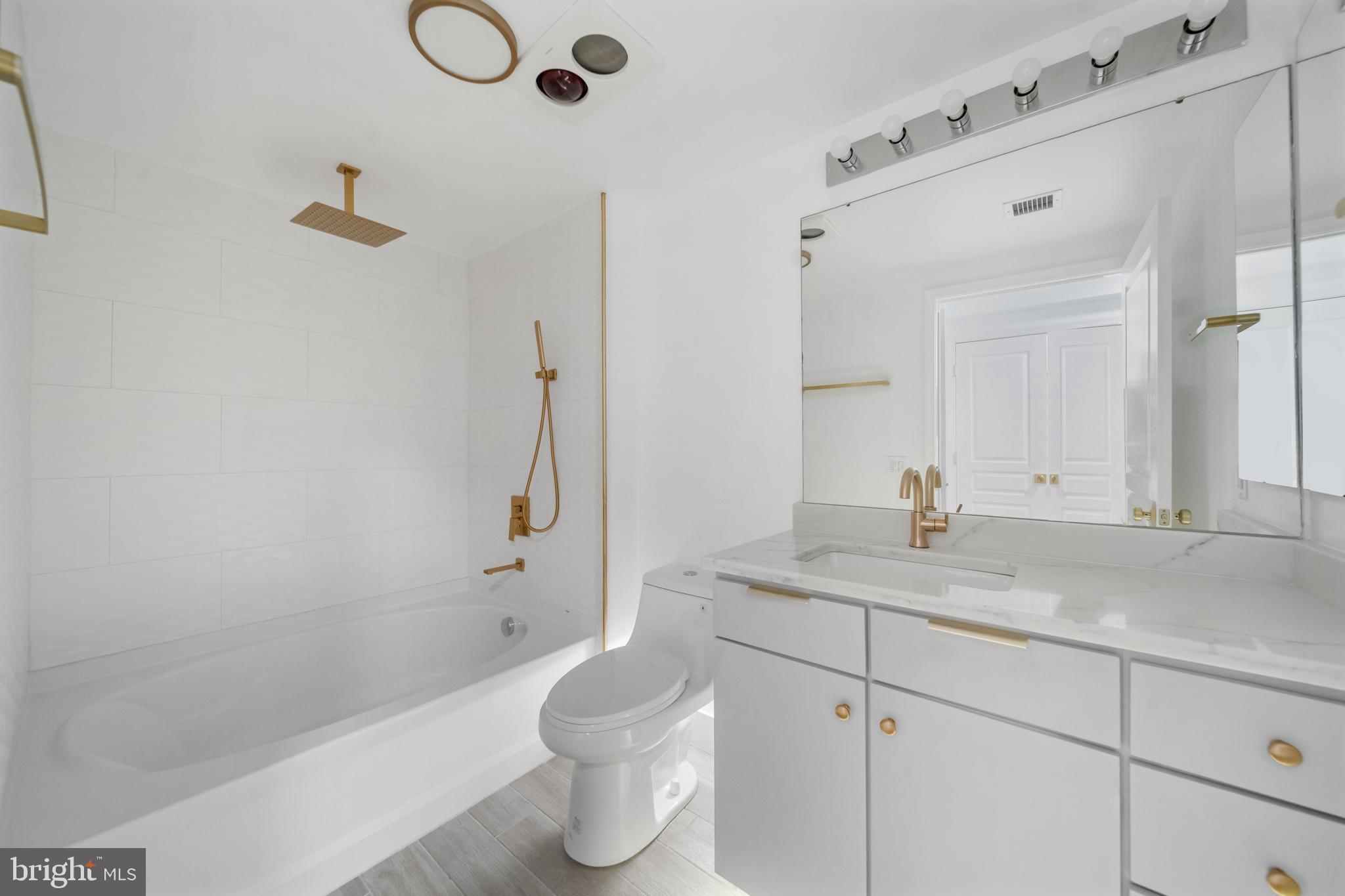 616 E Street Northwest, Unit 856 Washington, DC 20004 - Photo 34 of 84 a bathroom with a granite countertop sink a toilet and shower