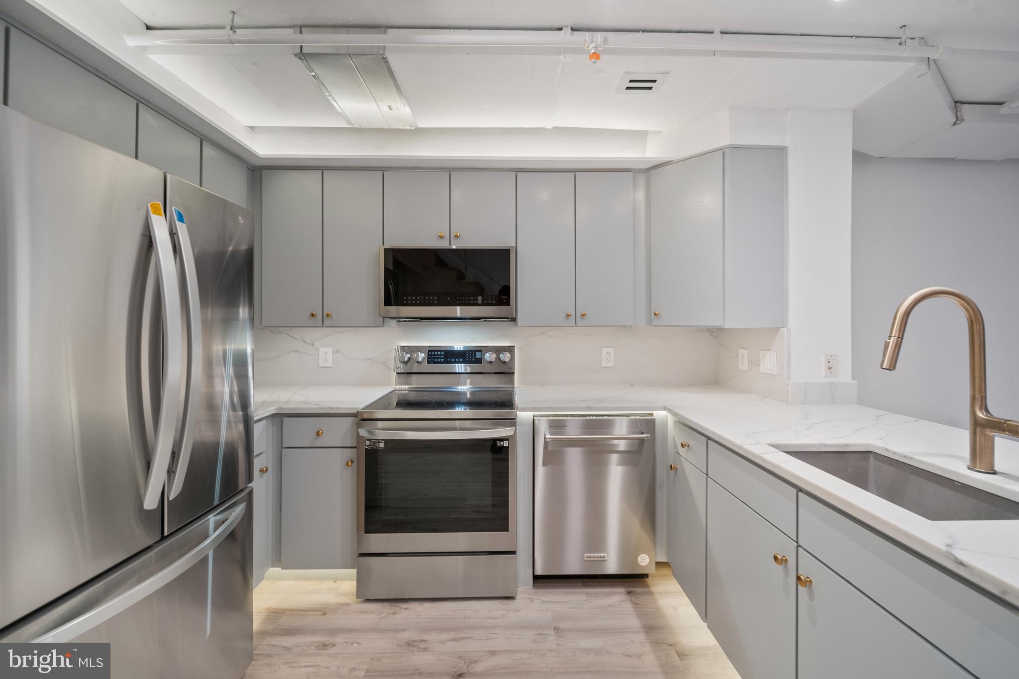 616 E Street Northwest, Unit 856 Washington, DC 20004 - Photo 6 of 84 a kitchen with stainless steel appliances a stove microwave and a refrigerator