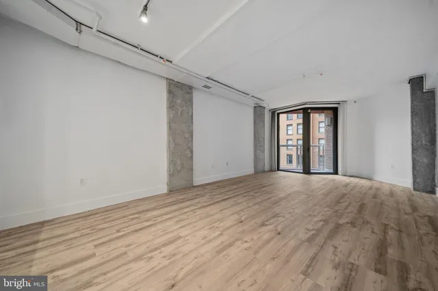 a view of a hallway with wooden floor and a fireplace