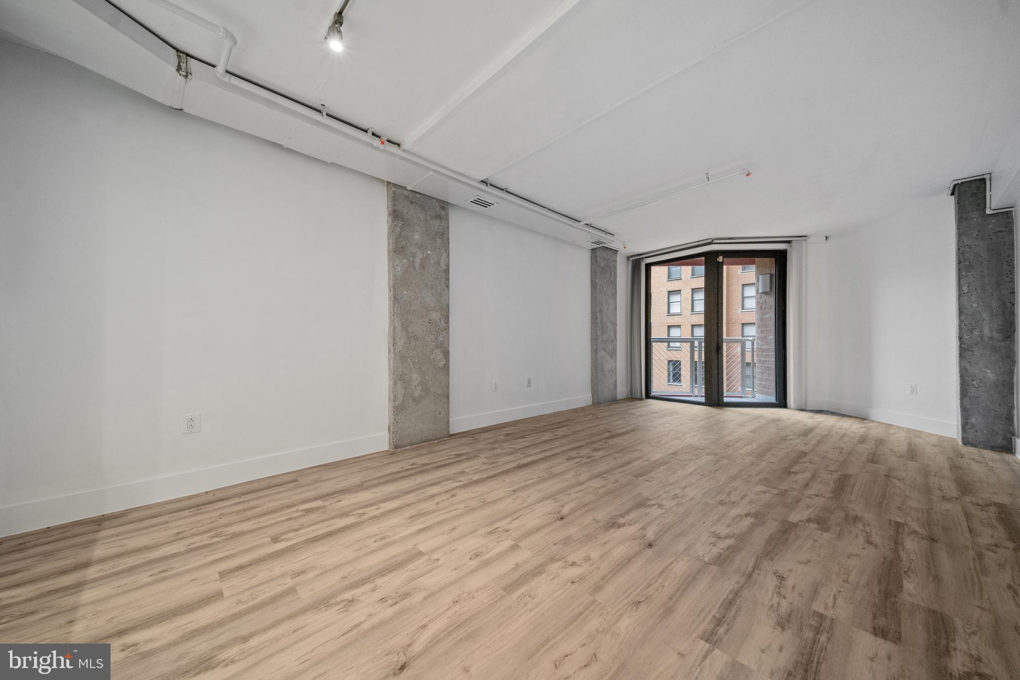616 E Street Northwest, Unit 856 Washington, DC 20004 - Photo 9 of 84 a view of empty room with wooden floor and fan