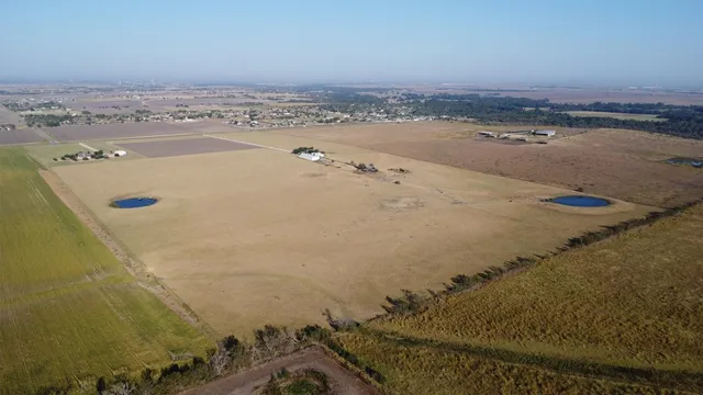 an aerial view of a house with a yard