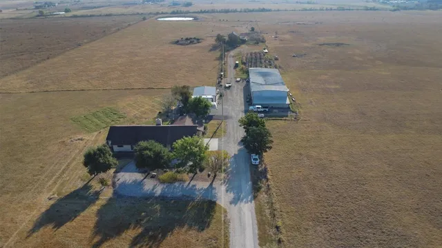 an aerial view of a house with a yard