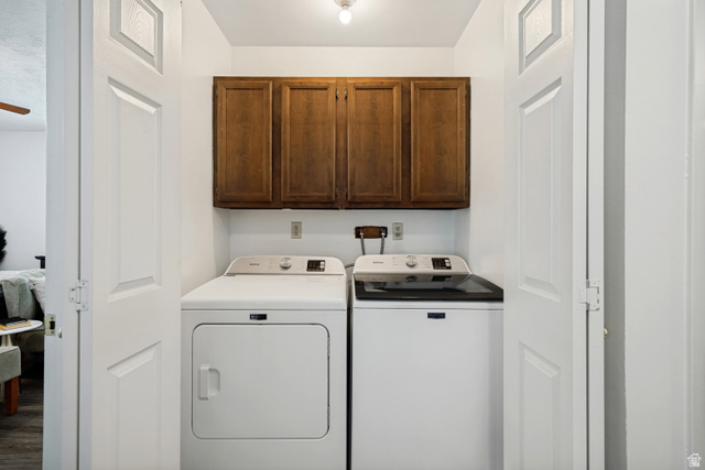 6709 Acoma Road, Unit 239 Midvale, UT 84047 - Photo 14 of 38 6711 - main level. Dedicated laundry area featuring a white top-load washing machine, white front-load dryer, and wood-finish upper cabinetry