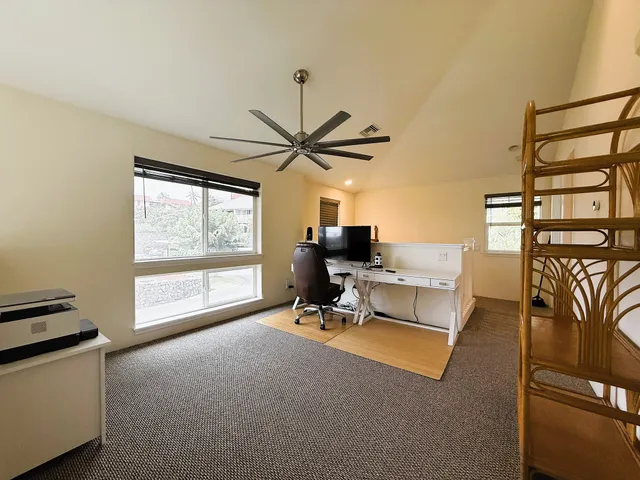 a view of a livingroom with workspace and a window
