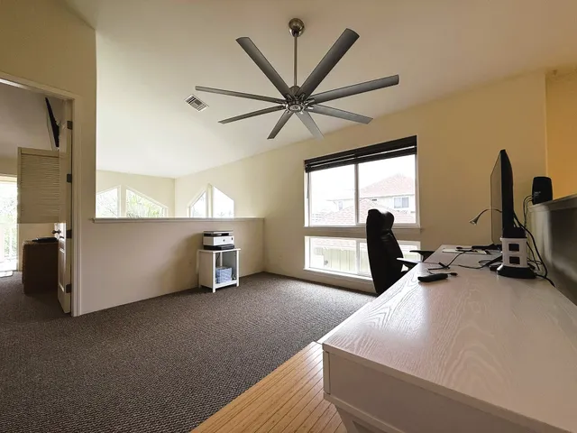 a view of a room with workspace and a window