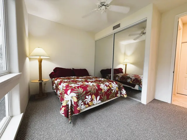 a bedroom with a bed lamp and a window