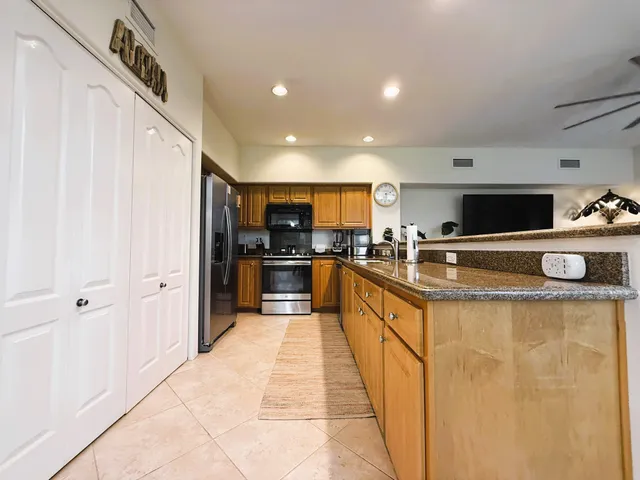 a kitchen with stainless steel appliances a refrigerator and a stove top oven