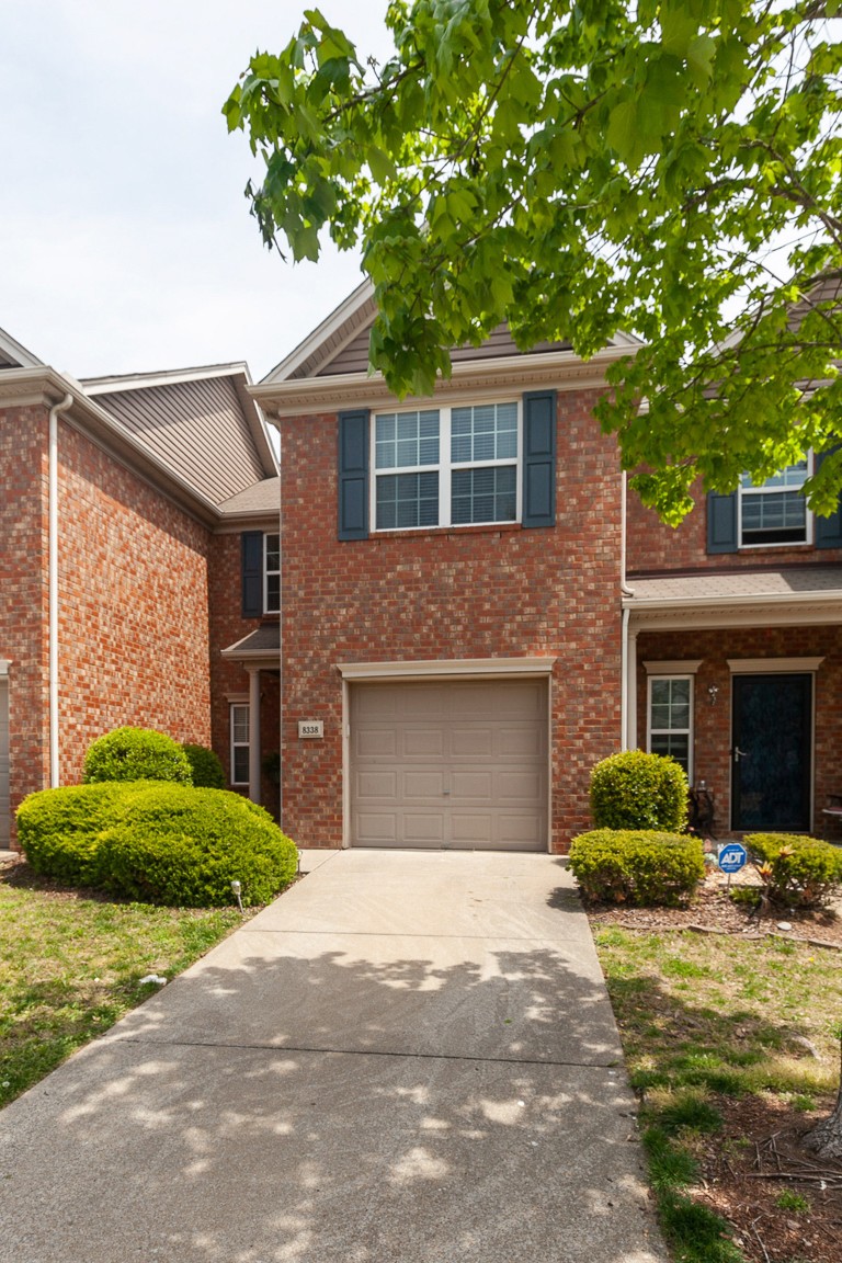 8338 Rossi Road Brentwood, TN 37027 - Photo 1 of 16 a front view of a house with a garden and garage