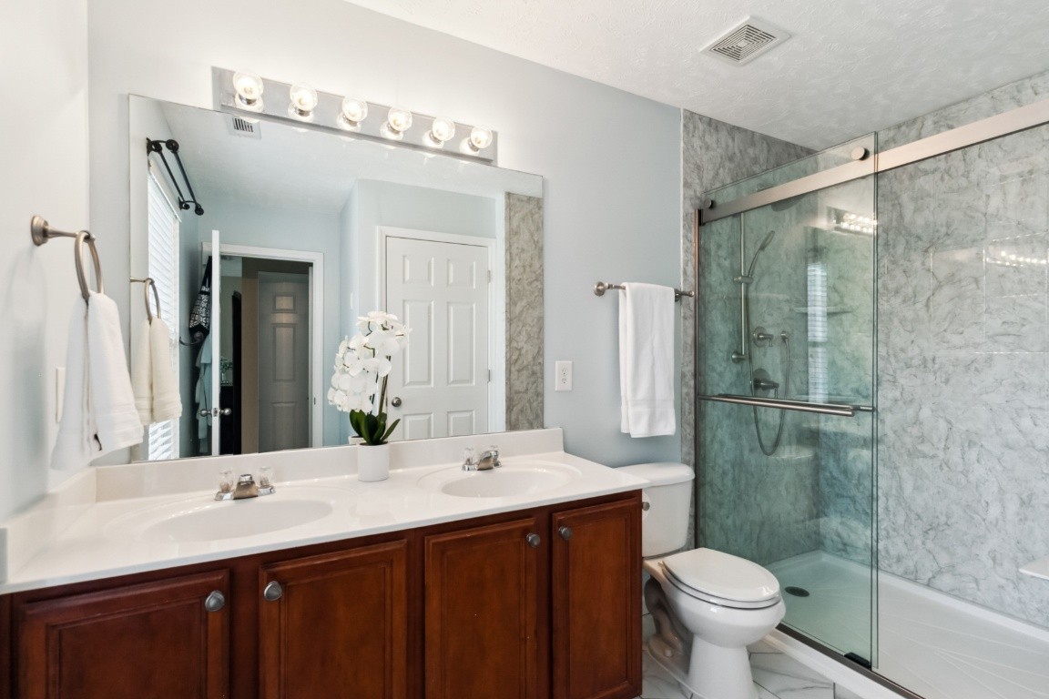 8338 Rossi Road Brentwood, TN 37027 - Photo 11 of 16 a bathroom with a double vanity sink mirror and toilet