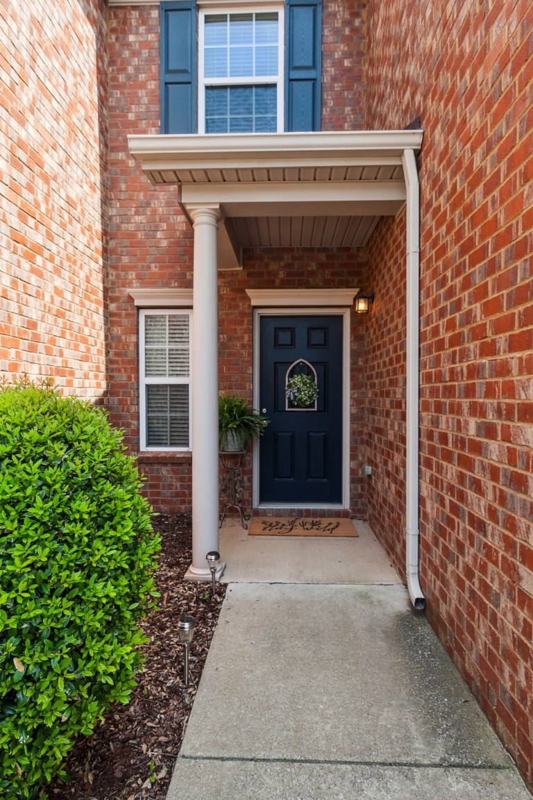 8338 Rossi Road Brentwood, TN 37027 - Photo 2 of 16 a front view of a house with potted plants