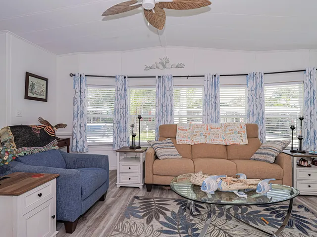 a kitchen with kitchen island granite countertop a sink cabinets and stainless steel appliances