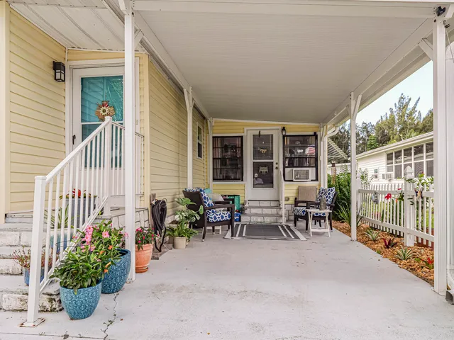 a view of a house with backyard sitting area and porch