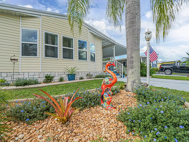 a view of a house with a yard and a garden