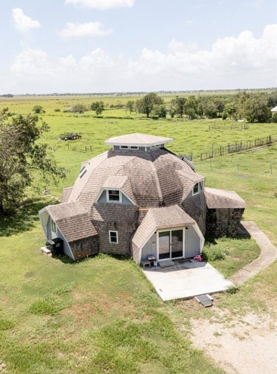 a aerial view of a house with big yard