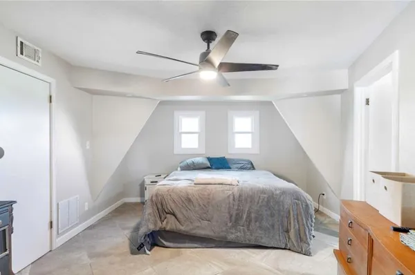 a bedroom with a bed and window