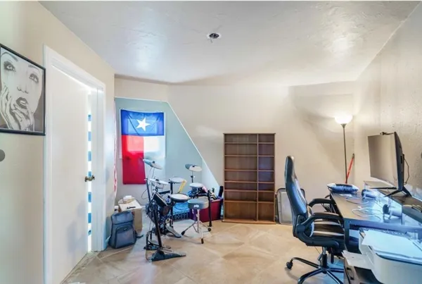 a view of a workspace with furniture and a window